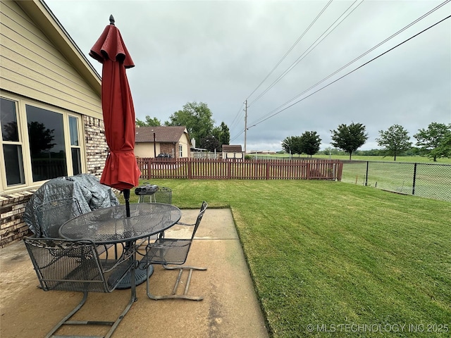 view of yard featuring a patio and outdoor dining space