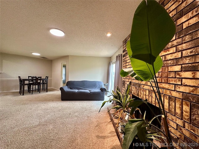 carpeted living area with a textured ceiling, a fireplace, brick wall, recessed lighting, and baseboards