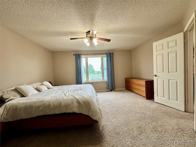 bedroom featuring light carpet, a textured ceiling, and ceiling fan