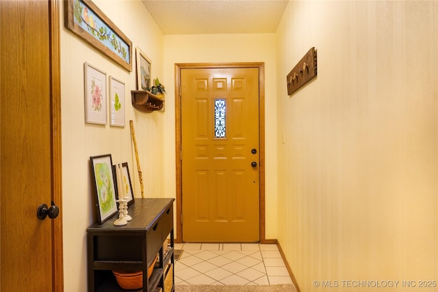 15919 E 79th St N, Owasso, OK 74055 - doorway featuring light tile patterned floors and a textured ceiling