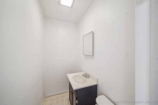 1010 S Wewoka Ave, Claremore, OK 74017 - bathroom featuring vanity, toilet, and baseboards
