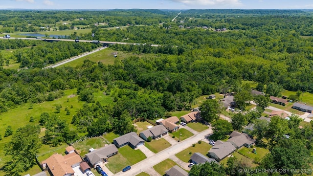1010 S Wewoka Ave, Claremore, OK 74017 - aerial view of property and surrounding area with a heavily wooded area and nearby suburban area