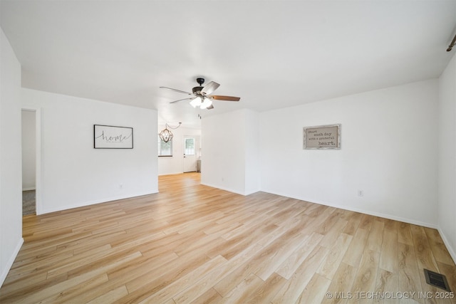 1010 S Wewoka Ave, Claremore, OK 74017 - unfurnished room featuring light wood-type flooring, ceiling fan, a chandelier, and baseboards