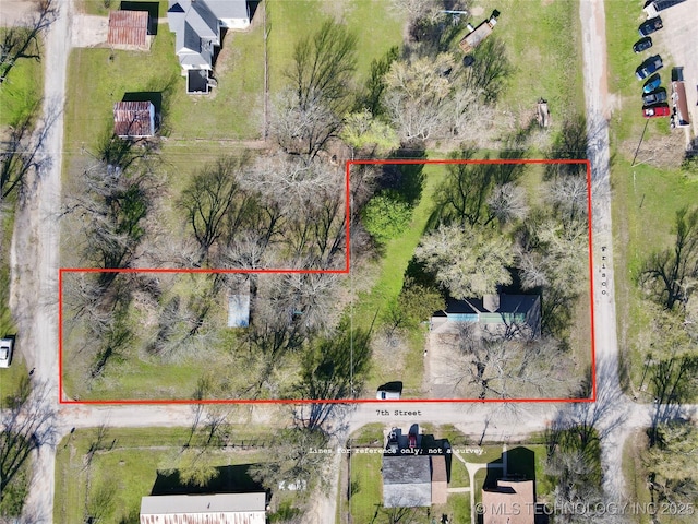 aerial view of property and surrounding area featuring property parcel outlined