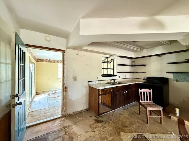 kitchen with dark brown cabinets, open shelves, wall chimney exhaust hood, a sink, and stove