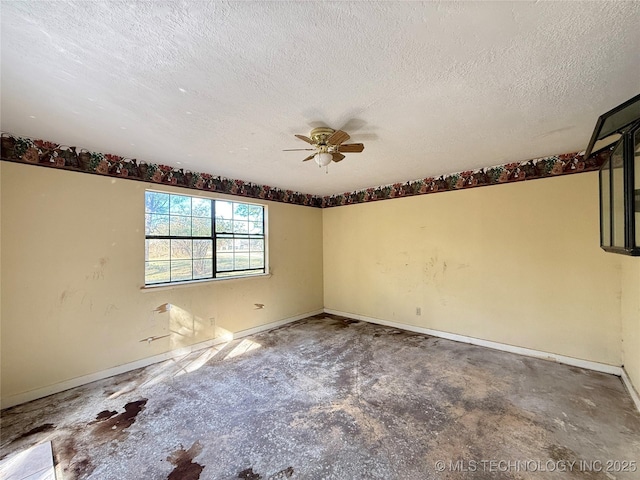 empty room featuring a textured ceiling, ceiling fan, baseboards, and concrete flooring