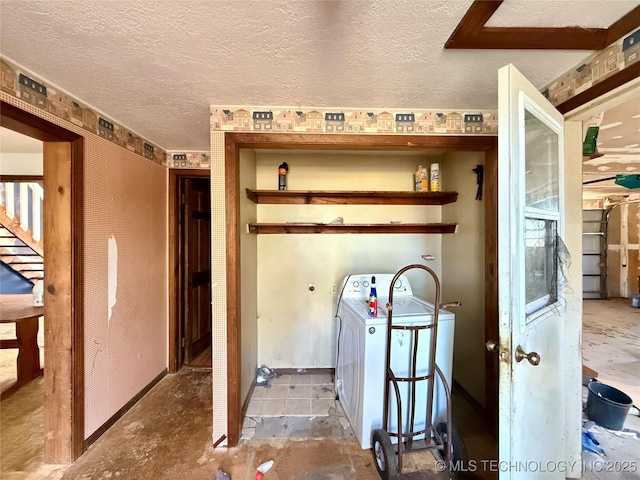 interior space featuring a textured ceiling and washer / clothes dryer