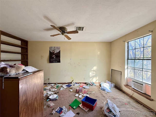 unfurnished living room featuring a textured ceiling, ceiling fan, and carpet floors