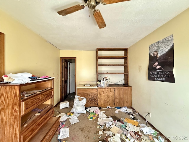carpeted dining room with ceiling fan and a textured ceiling