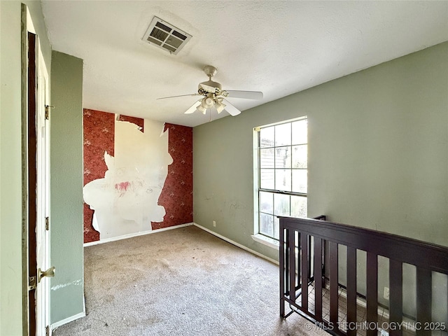 unfurnished bedroom with carpet floors, baseboards, and a ceiling fan