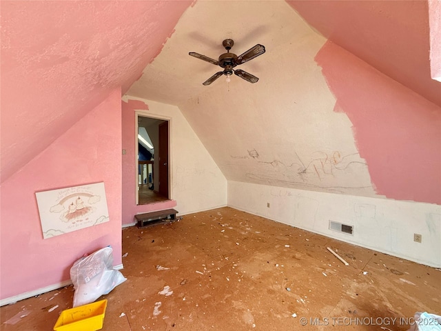additional living space featuring lofted ceiling and a ceiling fan