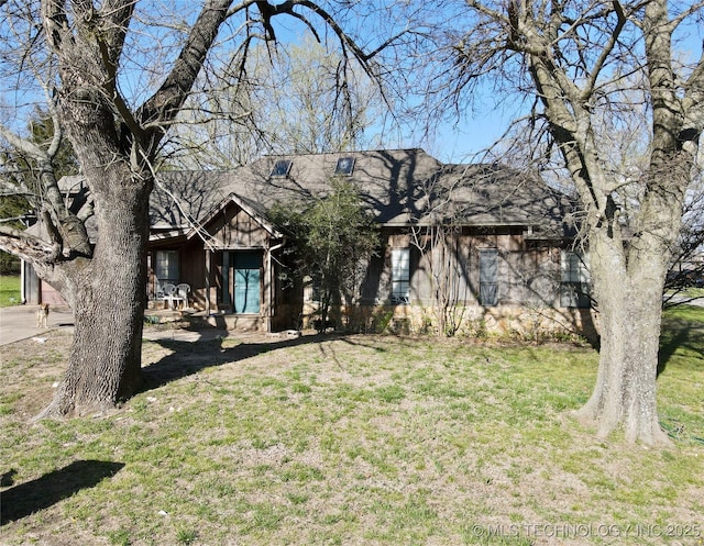 view of front facade with a front yard and board and batten siding