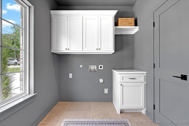 laundry room featuring hookup for an electric dryer, cabinet space, washer hookup, gas dryer hookup, and light tile patterned floors