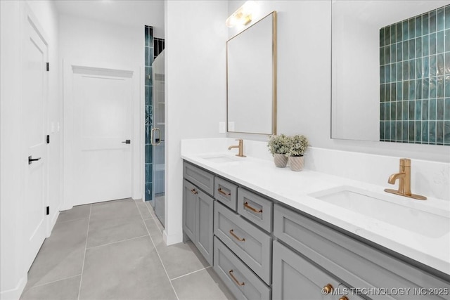 bathroom featuring double vanity, tile patterned flooring, and a shower stall