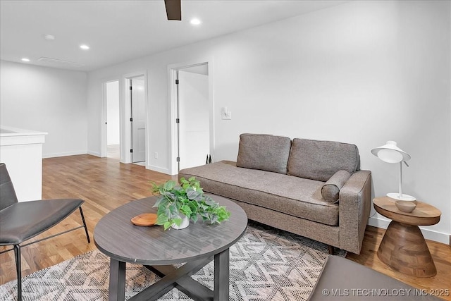 living area featuring wood finished floors, baseboards, recessed lighting, and a ceiling fan