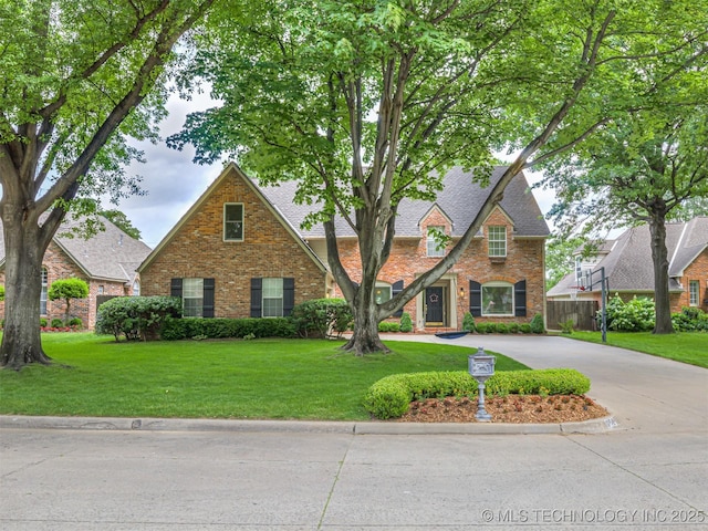 5517 E 101st Pl, Tulsa, OK 74137 - view of front of property with brick siding, a front lawn, driveway, and a shingled roof