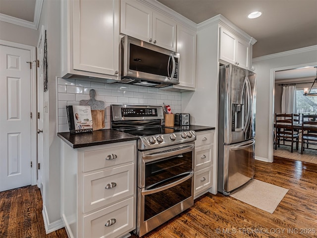 5517 E 101st Pl, Tulsa, OK 74137 - kitchen featuring stainless steel appliances, crown molding, dark countertops, white cabinets, and dark wood-style flooring