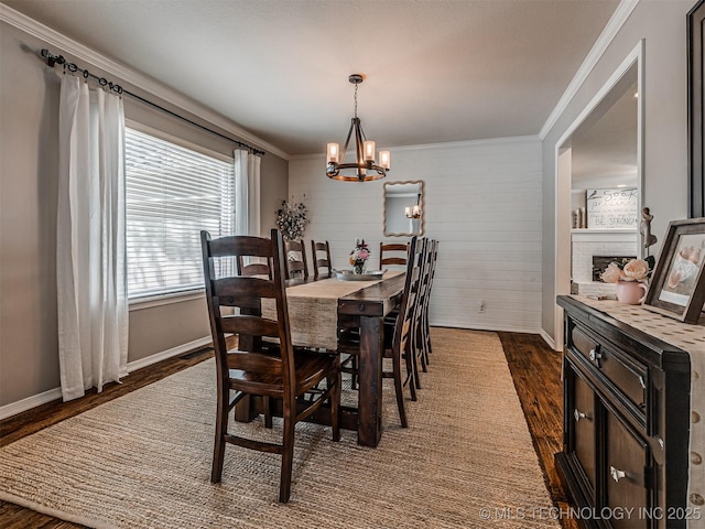 5517 E 101st Pl, Tulsa, OK 74137 - dining room featuring dark wood-type flooring, ornamental molding, a chandelier, baseboards, and a fireplace