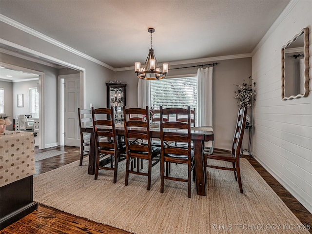 5517 E 101st Pl, Tulsa, OK 74137 - dining area featuring wood finished floors, healthy amount of natural light, a chandelier, and crown molding