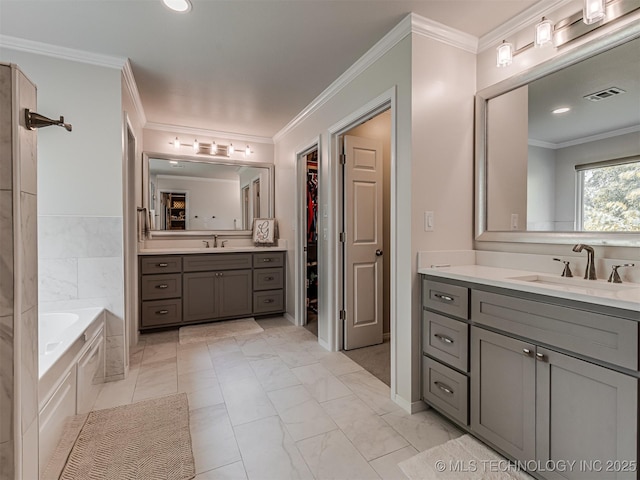 5517 E 101st Pl, Tulsa, OK 74137 - full bath with two vanities, a garden tub, a walk in closet, crown molding, and marble finish flooring
