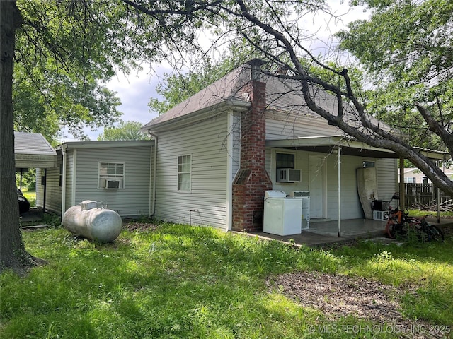 309 Albany St, Ketchum, OK 74349 - back of house featuring washer and dryer, cooling unit, and a yard