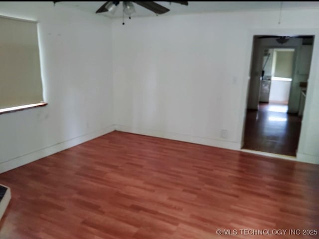 309 Albany St, Ketchum, OK 74349 - spare room featuring a ceiling fan, wood finished floors, and baseboards