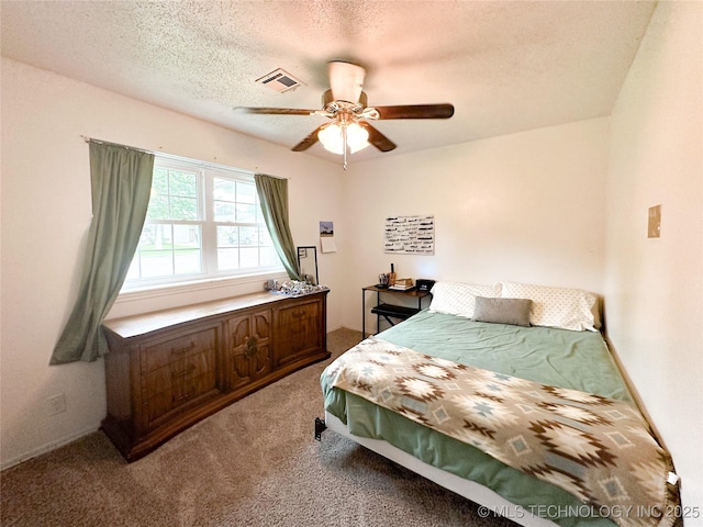602 S Elm St, Muldrow, OK 74948 - carpeted bedroom featuring a textured ceiling and a ceiling fan