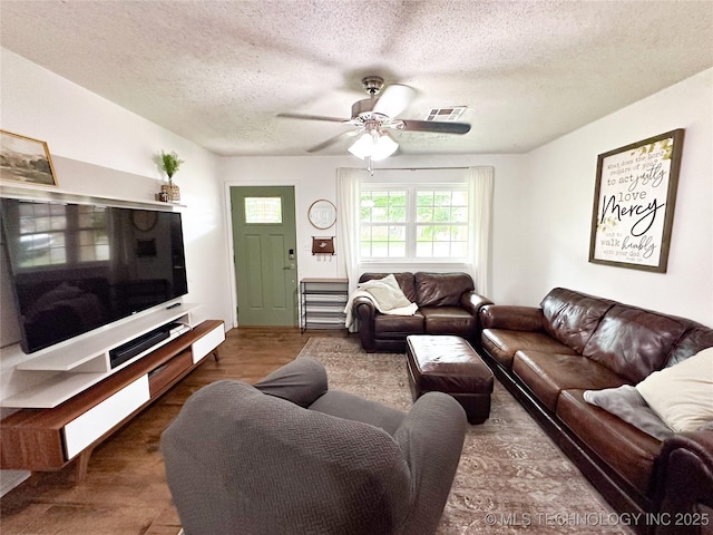 602 S Elm St, Muldrow, OK 74948 - living room featuring a textured ceiling, a ceiling fan, and wood finished floors