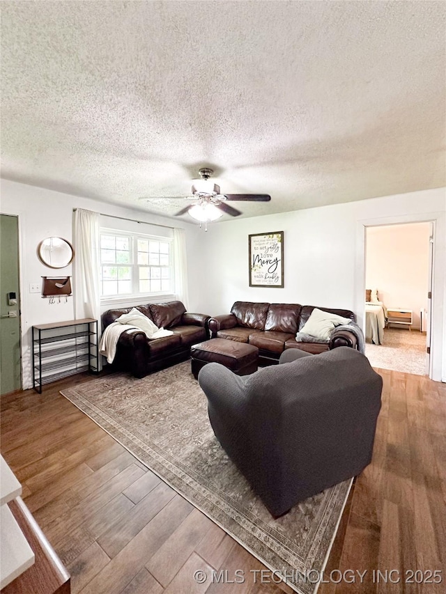 602 S Elm St, Muldrow, OK 74948 - living area with wood finished floors, a textured ceiling, and a ceiling fan