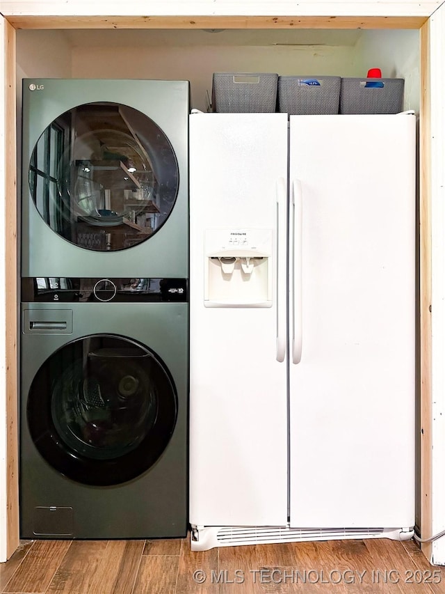 602 S Elm St, Muldrow, OK 74948 - clothes washing area with stacked washer / drying machine and wood finished floors