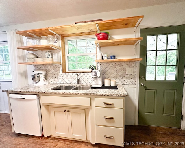 602 S Elm St, Muldrow, OK 74948 - kitchen featuring white dishwasher, open shelves, a sink, decorative backsplash, and wood finished floors
