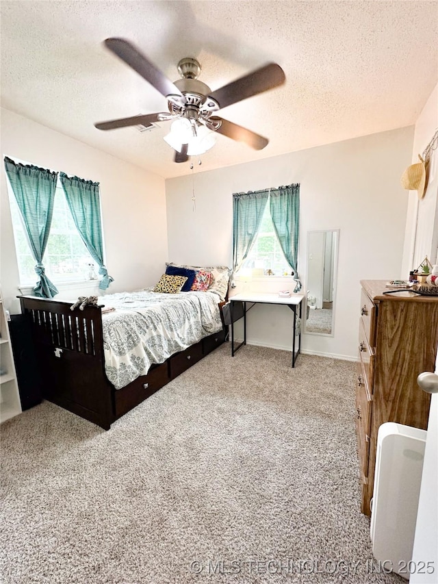 602 S Elm St, Muldrow, OK 74948 - bedroom featuring a textured ceiling, carpet floors, ceiling fan, and baseboards