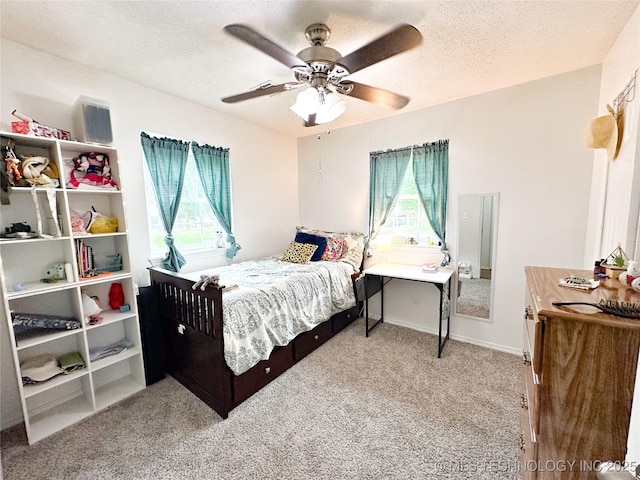 602 S Elm St, Muldrow, OK 74948 - carpeted bedroom with multiple windows, a textured ceiling, and ceiling fan
