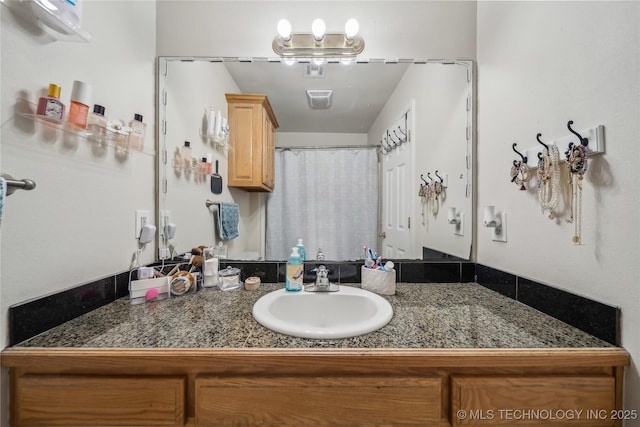 full bath featuring vanity and curtained shower