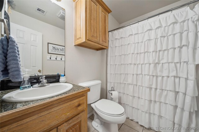 bathroom with toilet, tile patterned flooring, vanity, and a shower with shower curtain