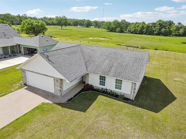aerial view of property and surrounding area with a tree filled landscape