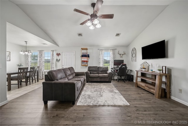 living area featuring lofted ceiling, ceiling fan, a chandelier, wood finished floors, and baseboards