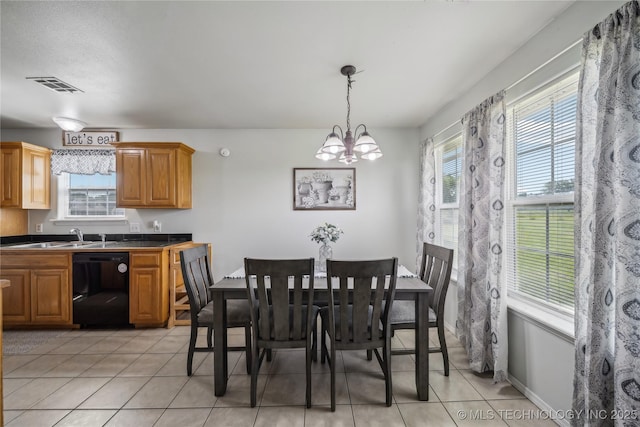 dining space with light tile patterned floors and a chandelier