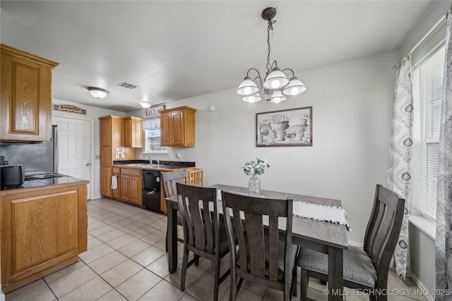 dining area featuring a chandelier and light tile patterned floors