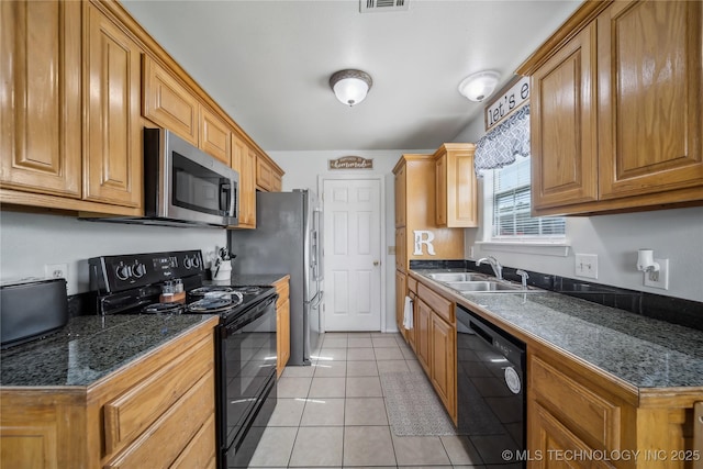 kitchen featuring black appliances, dark countertops, a sink, and light tile patterned floors