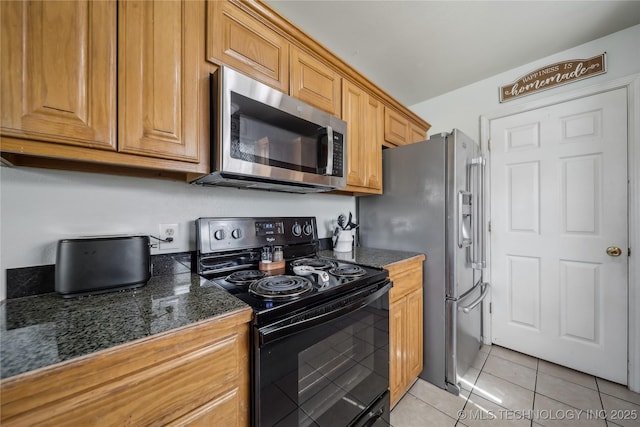kitchen featuring appliances with stainless steel finishes and light tile patterned flooring