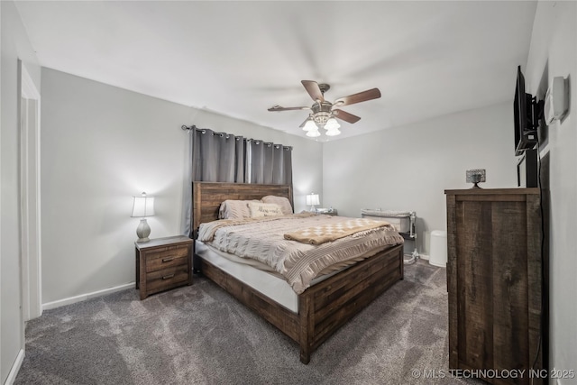 bedroom with dark colored carpet, ceiling fan, and baseboards