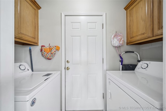 laundry area with washing machine and dryer and cabinet space