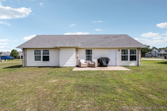 rear view of property featuring a patio area, a lawn, and a shingled roof