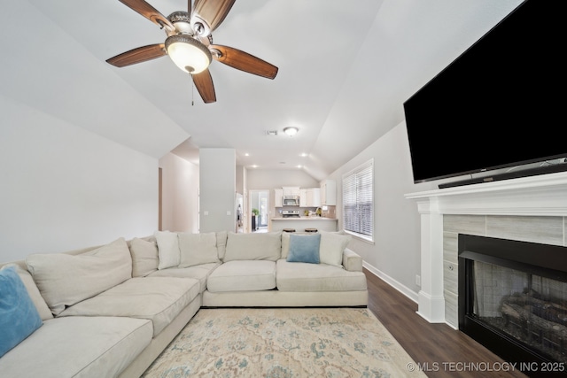 1414 W 114th St, Jenks, OK 74037 - living area with lofted ceiling, dark wood-style flooring, ceiling fan, a fireplace, and baseboards
