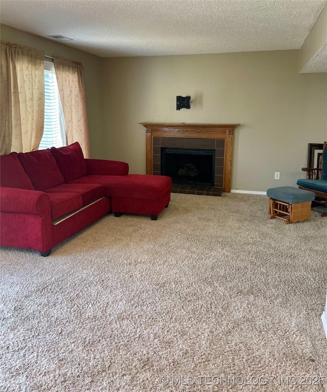 3164 S 101st E Ave Unit 801, Tulsa, OK 74146 - living room featuring carpet flooring, a fireplace, and a textured ceiling