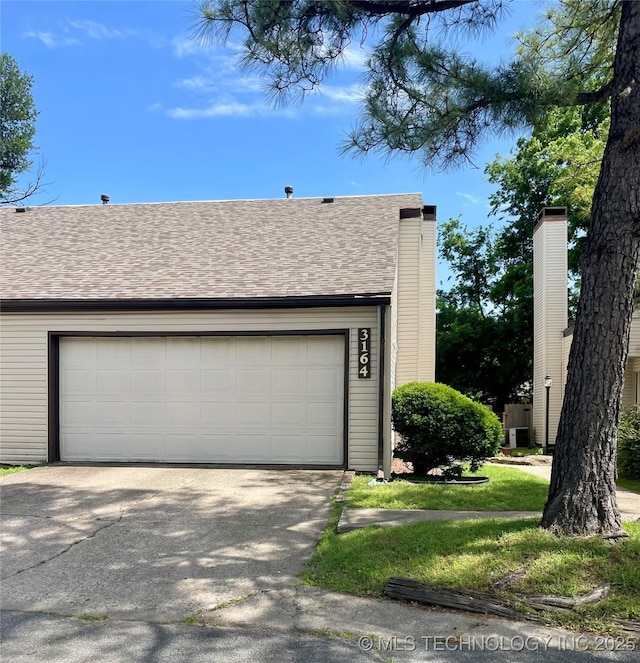 3164 S 101st E Ave Unit 801, Tulsa, OK 74146 - garage featuring driveway