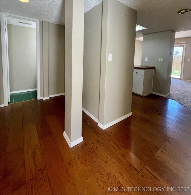 3164 S 101st E Ave Unit 801, Tulsa, OK 74146 - hall with a textured ceiling, hardwood / wood-style floors, and baseboards