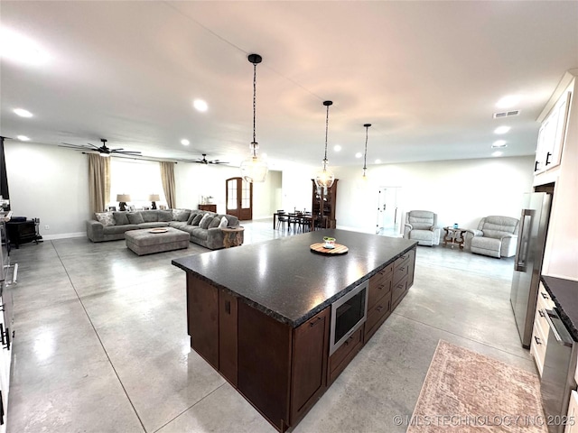 116645 S 4215th Rd, Eufaula, OK 74432 - kitchen featuring open floor plan, stainless steel appliances, concrete flooring, dark brown cabinets, and recessed lighting