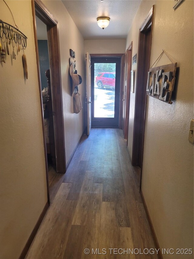 363 W 1700th Rd, Stigler, OK 74432 - hallway featuring wood finished floors and baseboards